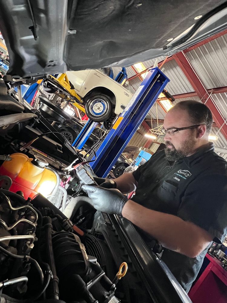 Joe's Auto Service Centre mechanic using diagnostic equipment in the Forster workshop